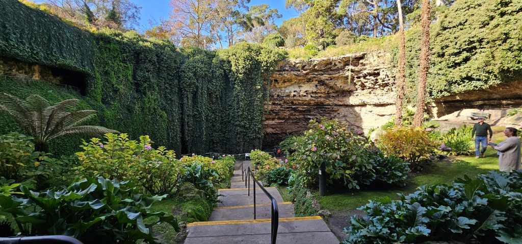 Lush garden with stone walls.