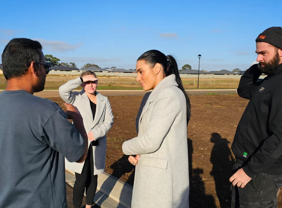 Group of people talking outdoors.