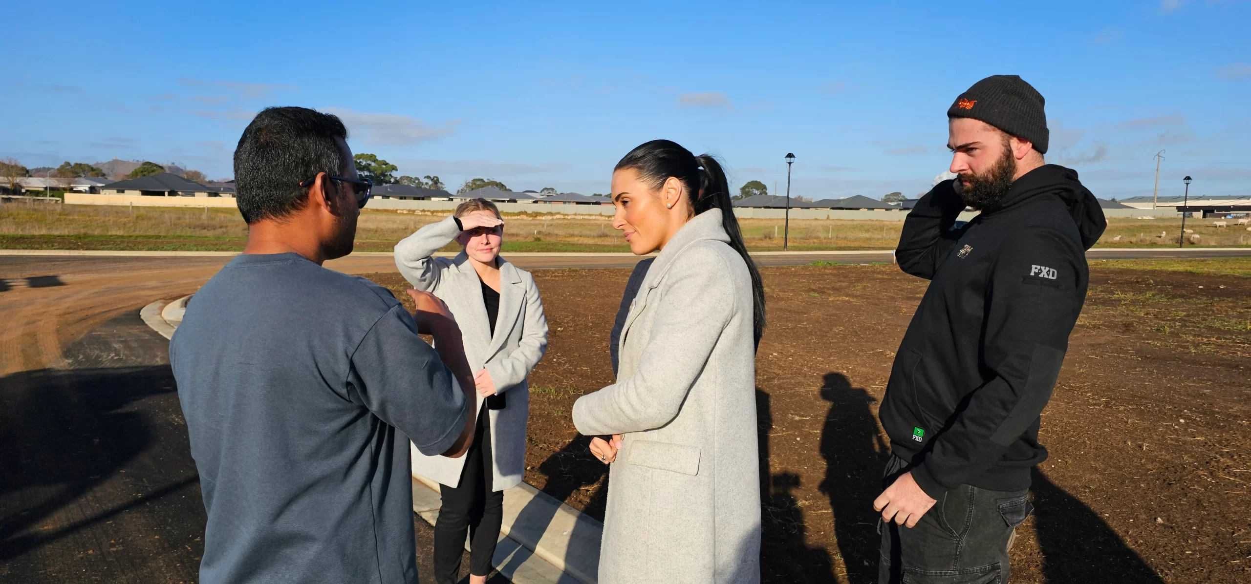 Group of people talking outdoors.