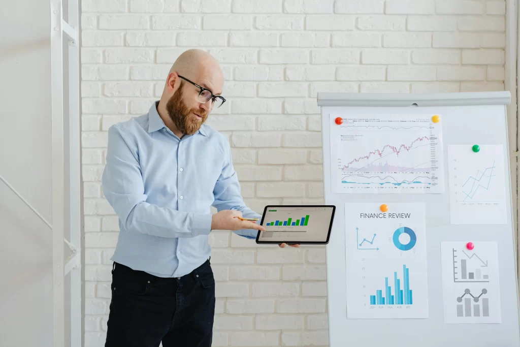 a man standing in front of a white board