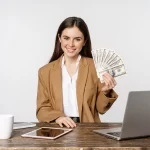 Person holding cash at desk