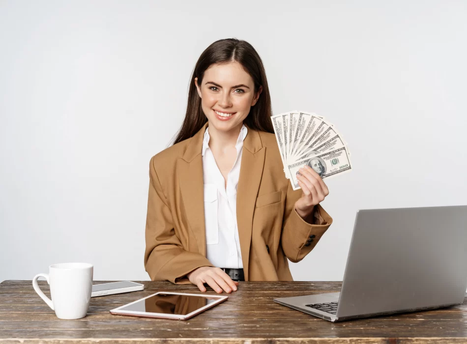 Person holding cash at desk