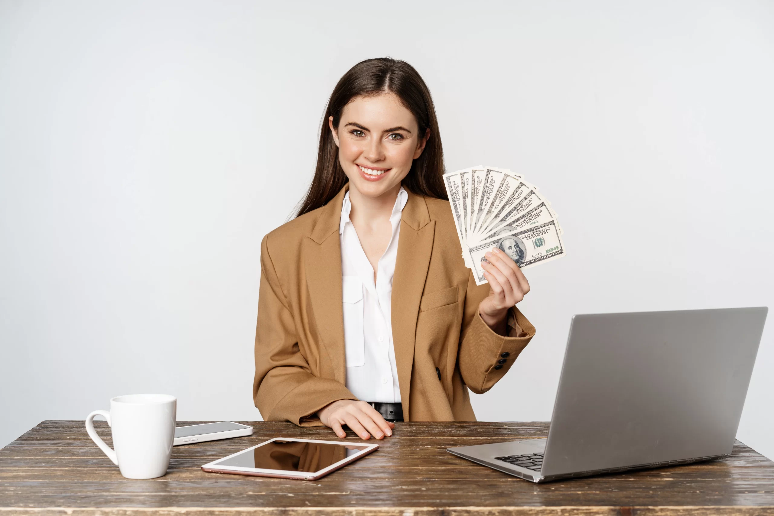 Person holding cash at desk