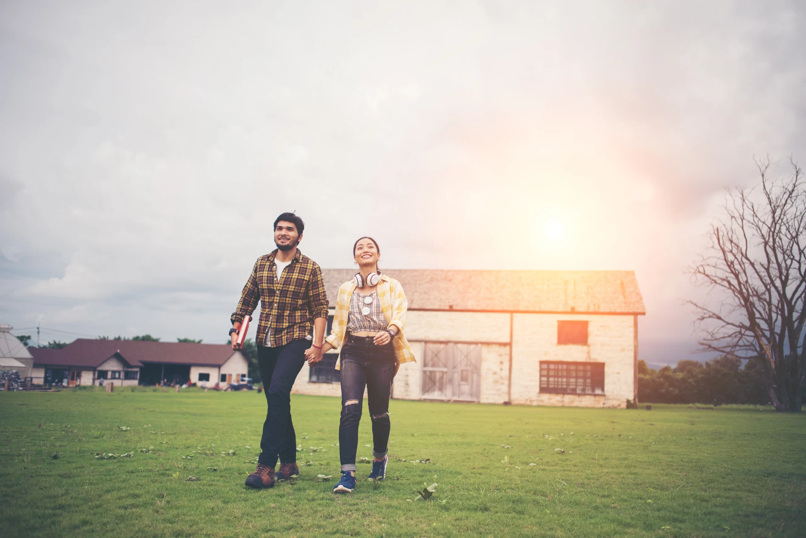 Two students walking in a field.